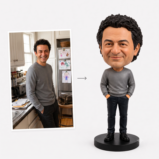 Photo of a smiling man in a grey sweater next to the custom bobblehead figure sculpted from that same photo